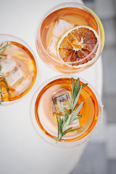 Arial photo of three orange cocktail with ice on a summer day